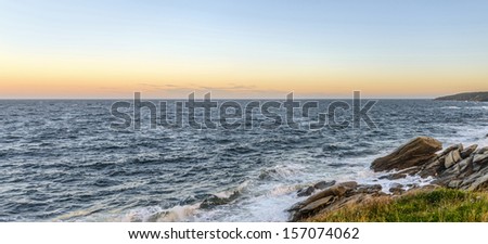 Panorama of an ocean shore at the crack of dawn (Cape Breton, Nova Scotia, Canada)