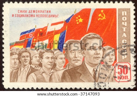USSR -CIRCA 1967: The Soviet stamp. People go with a flag, circa 1967.