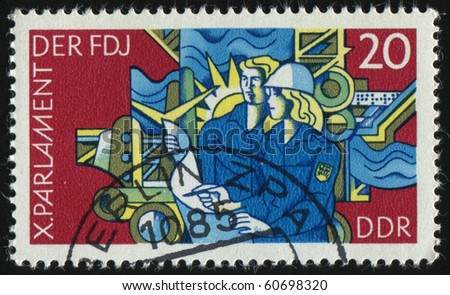 GERMANY- CIRCA 1976: stamp printed by Germany, shows Young man and woman industrial installations, circa 1976.