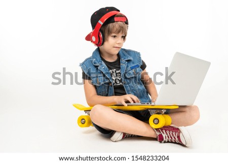 Stock Photo Teenager Boy Sits On Floor In Denim Jacket And Shorts Sneakers With Yellow Penny Red Earphones 1548233204 