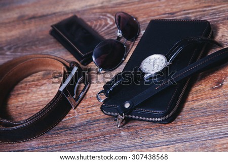 Photo men's accessories , including watches, wallets , sunglasses and housekeeper.
Picture with depth of field and Art Filters