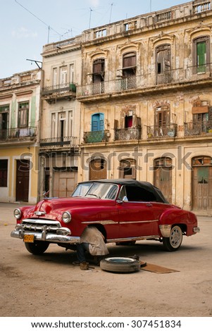 Cuba Havana 2005 Year December 15 .Man repair the old American car in Havana Street