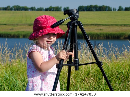 Little Photographer with Professional Tripod, River Background,  Outdoor