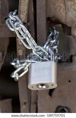 Padlock and chain on an old rusty door