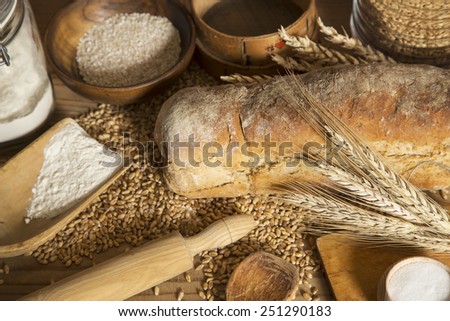 Home made bread, wheat and kitchen utensils