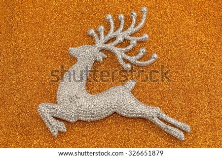 Shinny Christmas deer on a sparkle orange background