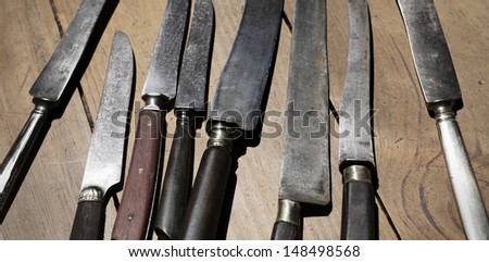 antique knifes on wooden background