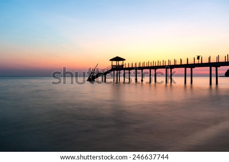Beautiful sunset at tropical beach with jetty