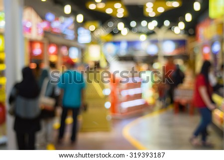 Blurred image of people in store outlet.