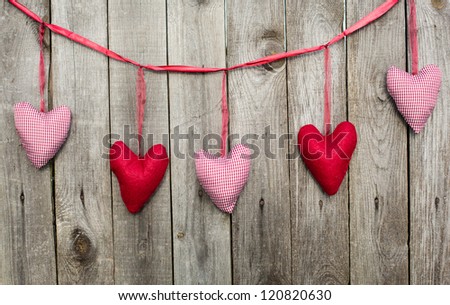Set of holiday hearts on woody background