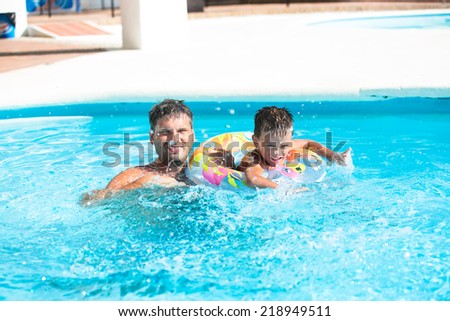 Father have fun with the son in the pool