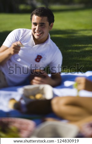 Young man enjoying picnic with friends