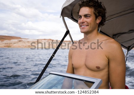 Happy young man driving boat