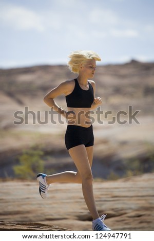 Young woman running in landscape