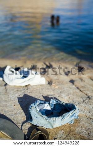 Closeup of clothes left by people swimming in sea