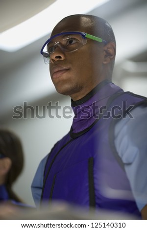 Low angle view of a male x-ray technician wearing protective glasses