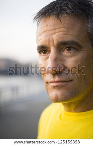 Portrait of a middle aged male jogger looking away