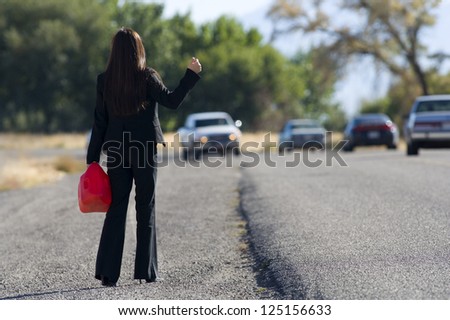 Woman out of gas standing by the road