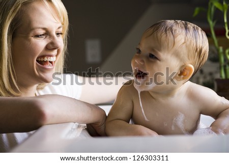 Motion blur shot of a mother bathing her little daughter