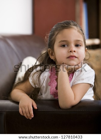 Young Girl Sitting On Leather Sofa Stock Photo 127810433 : Shutterstock