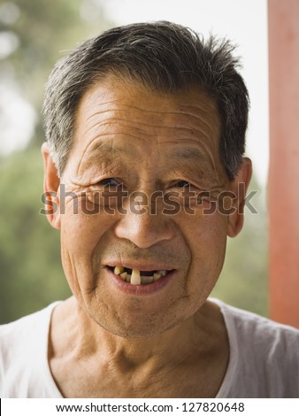 Portrait of a toothless man outdoors smiling