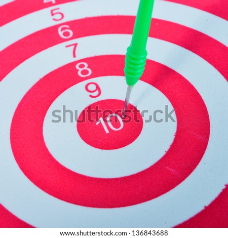 Arrows dart hitting the center of a target, success business concept