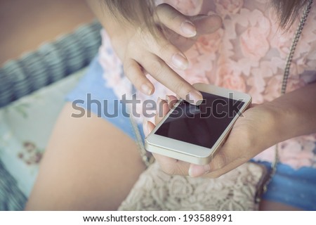 women using a smart phone, hand touch on screen digital mobile, shallow depth of field image vintage tone