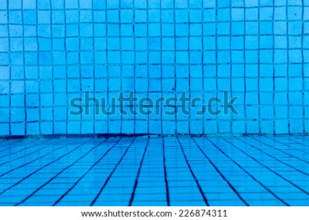 blue tile floor under water of swimming pool