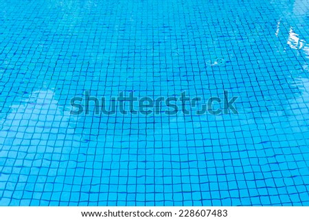 blue tile floor under water of swimming pool texture