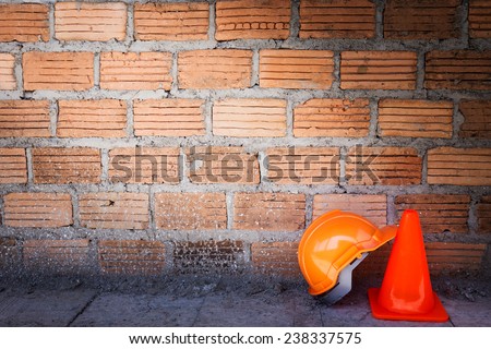 construction helmet safety and cone in construction site with bricks