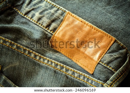 brown leather tag on black jeans