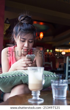 women lifestyle used a mobile phone in cafe coffee shop with texting message on app smartphone playing social network