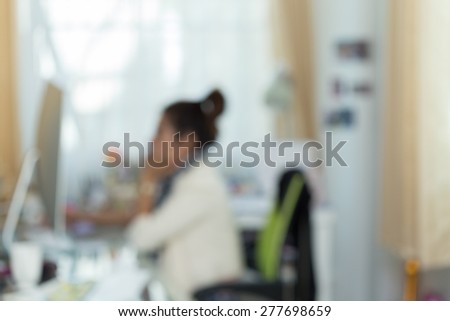working woman with computer, image blur background