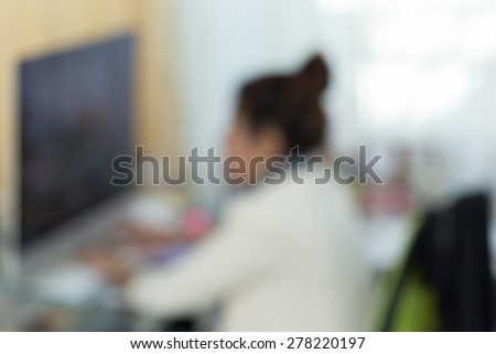 working woman with computer, image blur background