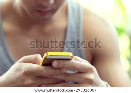 lifestyle young man using a mobile phone with texting message on app smartphone, playing social network and shopping online