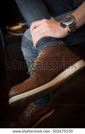 brown boot leather shoes and jean pants clothing fashion of man