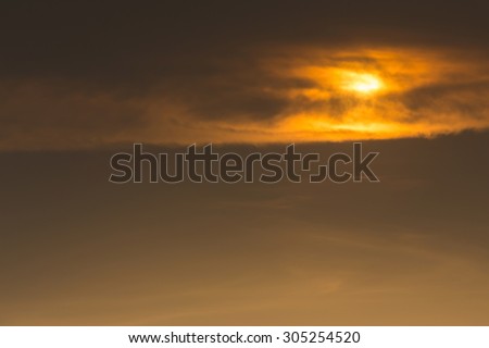 golden sky with clouds cover sun