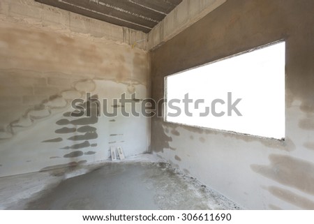 empty cement concrete room in construction work with white window blank space