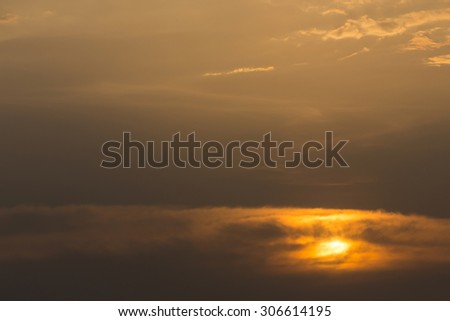 golden sky with clouds cover sun