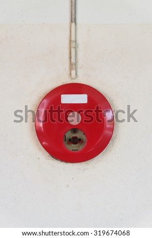 red fire alarm box for warning security system mounted on wall