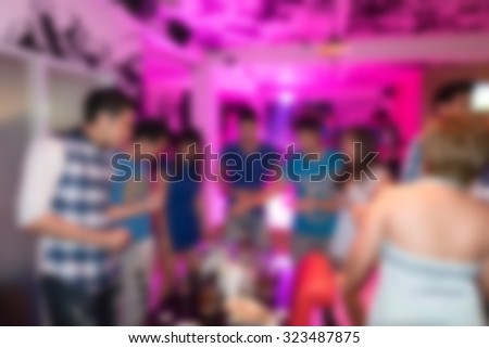 image blurred background, group of young people having joyful dancing in nightclub party