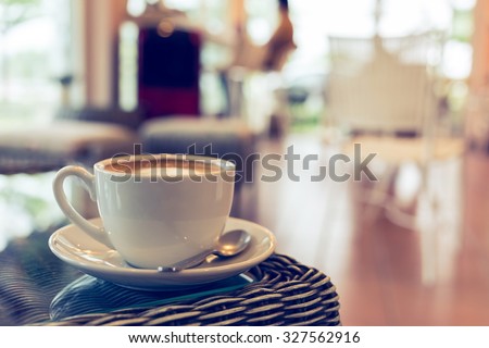 coffee cup on table with blur interior cafe coffee shop background