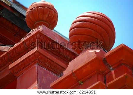 Ornamental clay red orbs atop an old downtown bank building