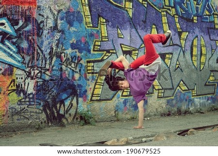 Teenager dancing break dance in the street