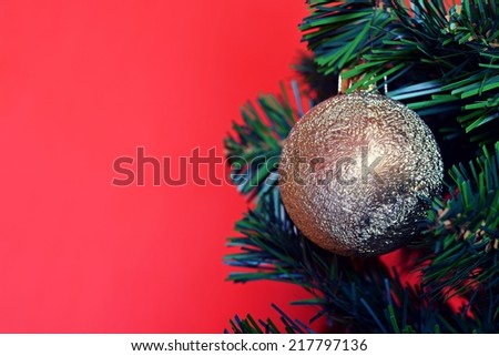 Christmas ball, tree and red background for text