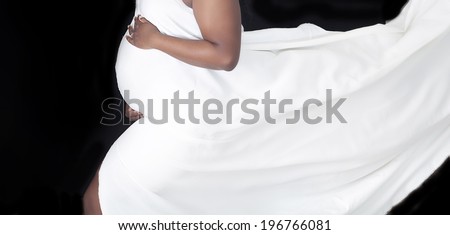 Pregnant woman\'s belly with flowing fabric