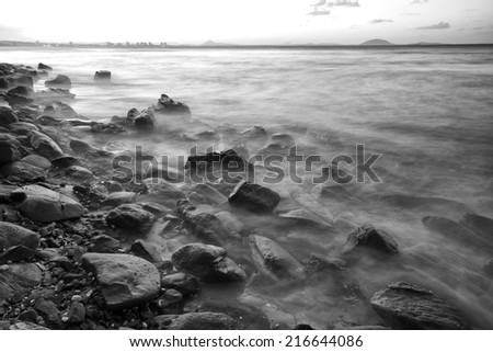 Black and white image of rocks at the beach in the Sunshine Coast, Queensland - Australia.