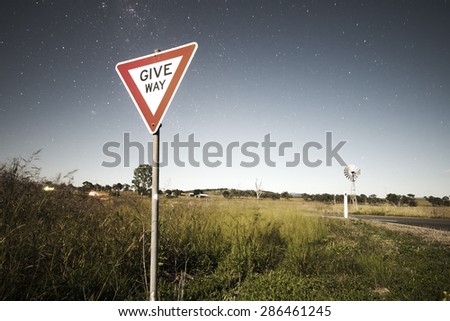 Road sign with stars in the background in the outback of Queensland, Australia. High Noise.