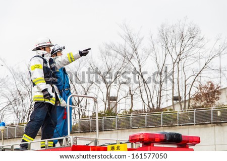 Kanagawa, Japan - January 5: The fire fighters on the rescue car perform fire fighting show in the New Year's Fire Review at Nissan Stadium on January 5, 2013 in Kanagawa, Japan.
