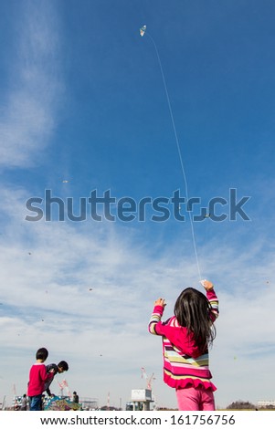 Kanagawa, Japan - January 13: Unidentified children fly Kites in the New Year\'s Kite Festival at Nissan Stadium on January 13, 2013 in Kanagawa, Japan.